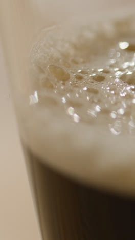 Vertical-Video-Close-Up-Of-Pint-Of-Irish-Stout-In-Glass-To-Celebrate-St-Patricks-Day-1